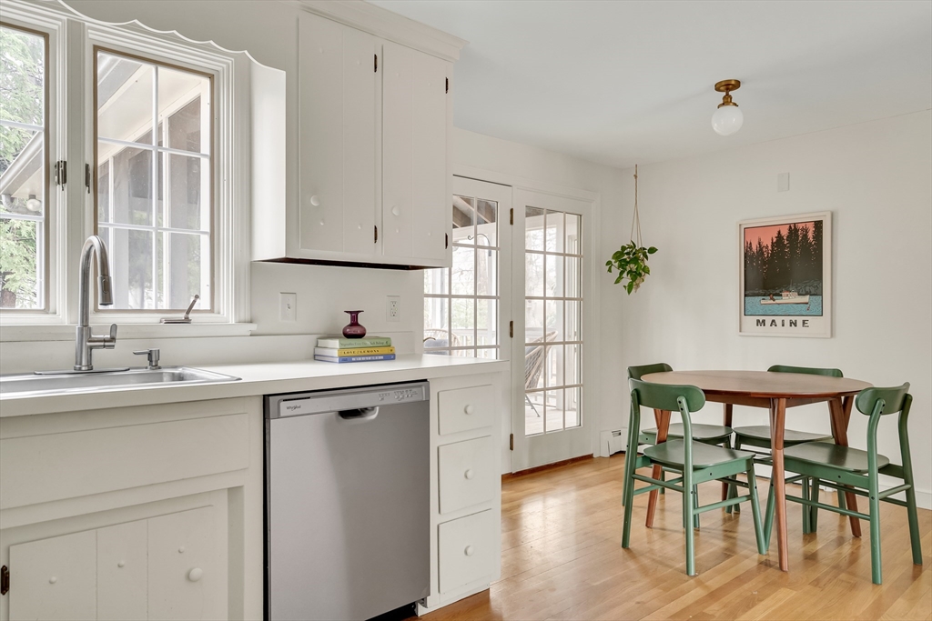 8 Highland Road Acton, MA 01720 - Photo 16 of 36 a kitchen with a table chairs sink and cabinets