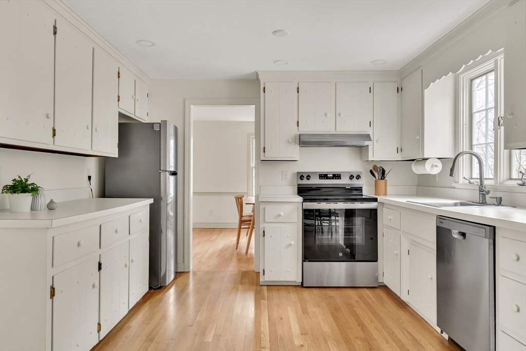 8 Highland Road Acton, MA 01720 - Photo 17 of 36 a kitchen with cabinets stainless steel appliances a sink and wooden floor
