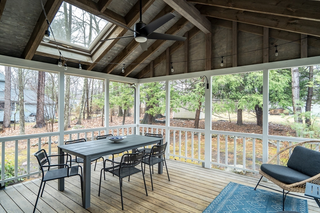 8 Highland Road Acton, MA 01720 - Photo 21 of 36 a view of a patio with table and chairs and wooden floor