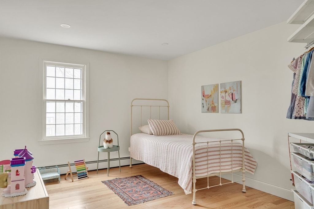 8 Highland Road Acton, MA 01720 - Photo 29 of 36 a bedroom with a bed and wooden floor