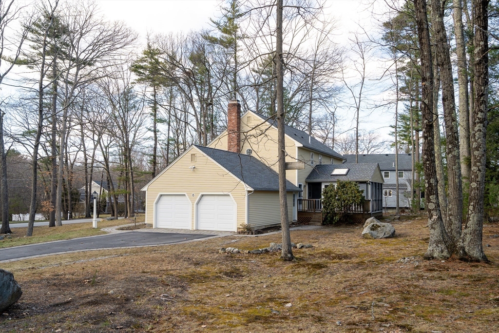 8 Highland Road Acton, MA 01720 - Photo 3 of 36 a backyard of a house with fire pit and trees