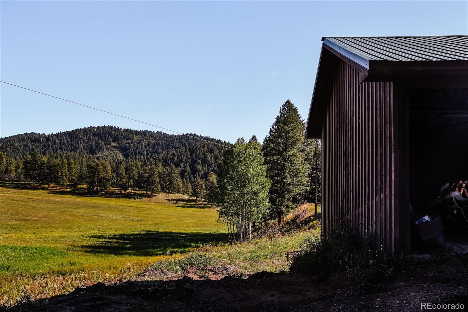 375 Pine Creek Road Sedalia, CO 80135 - Photo 11 of 48 a view of a television in the backyard of a house