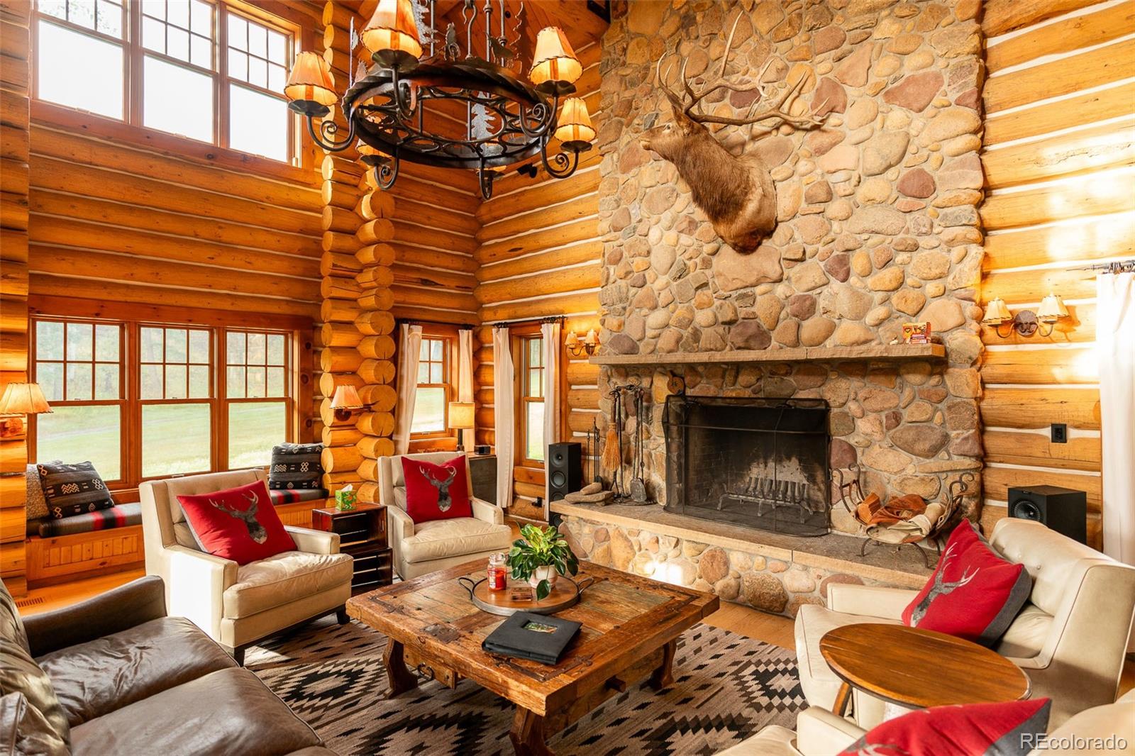 375 Pine Creek Road Sedalia, CO 80135 - Photo 14 of 48 a living room with furniture and a fireplace
