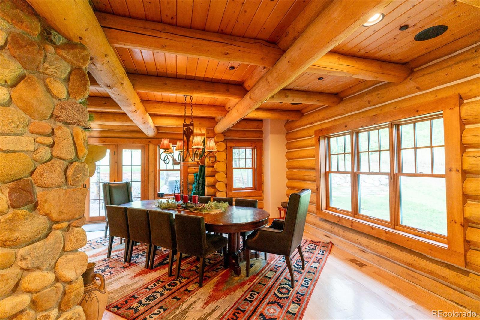 375 Pine Creek Road Sedalia, CO 80135 - Photo 18 of 48 a view of a dining room with furniture a chandelier and wooden floor