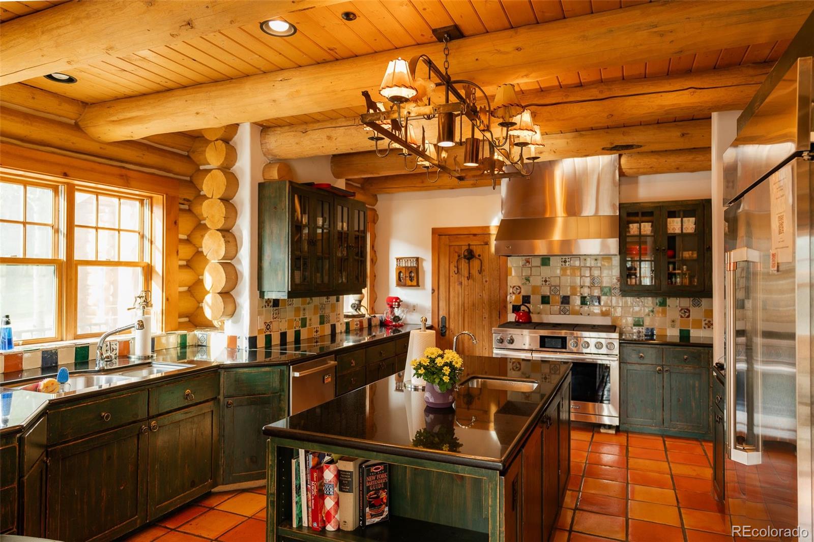 375 Pine Creek Road Sedalia, CO 80135 - Photo 22 of 48 a kitchen with a sink stove and cabinets