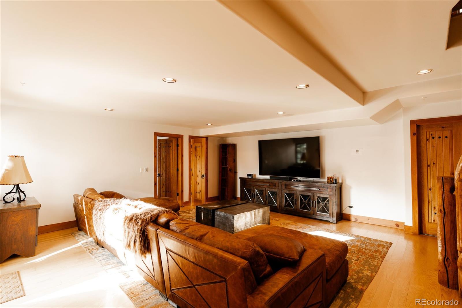 375 Pine Creek Road Sedalia, CO 80135 - Photo 25 of 48 a living room with furniture and a flat screen tv