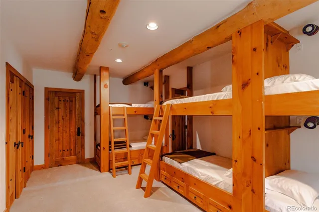 a view of a dining room with furniture a chandelier and wooden floor