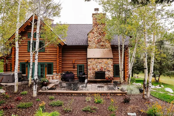 a view of backyard of house with outdoor seating