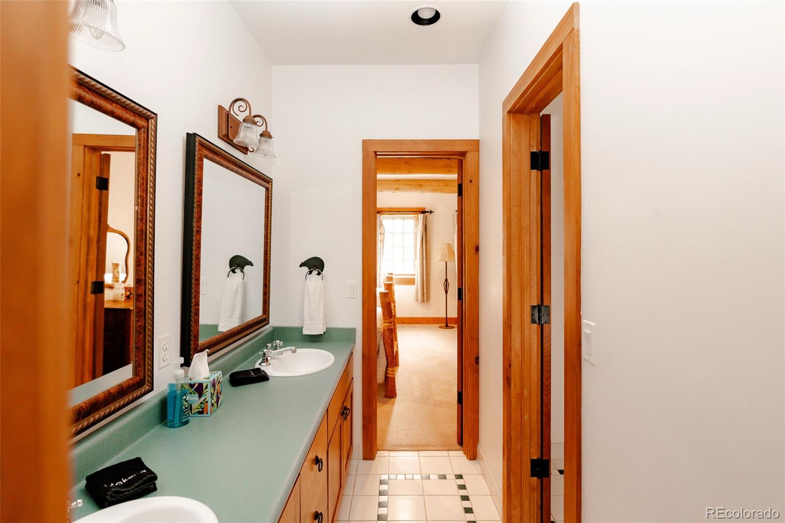 375 Pine Creek Road Sedalia, CO 80135 - Photo 31 of 48 a bathroom with a sink a mirror and shower