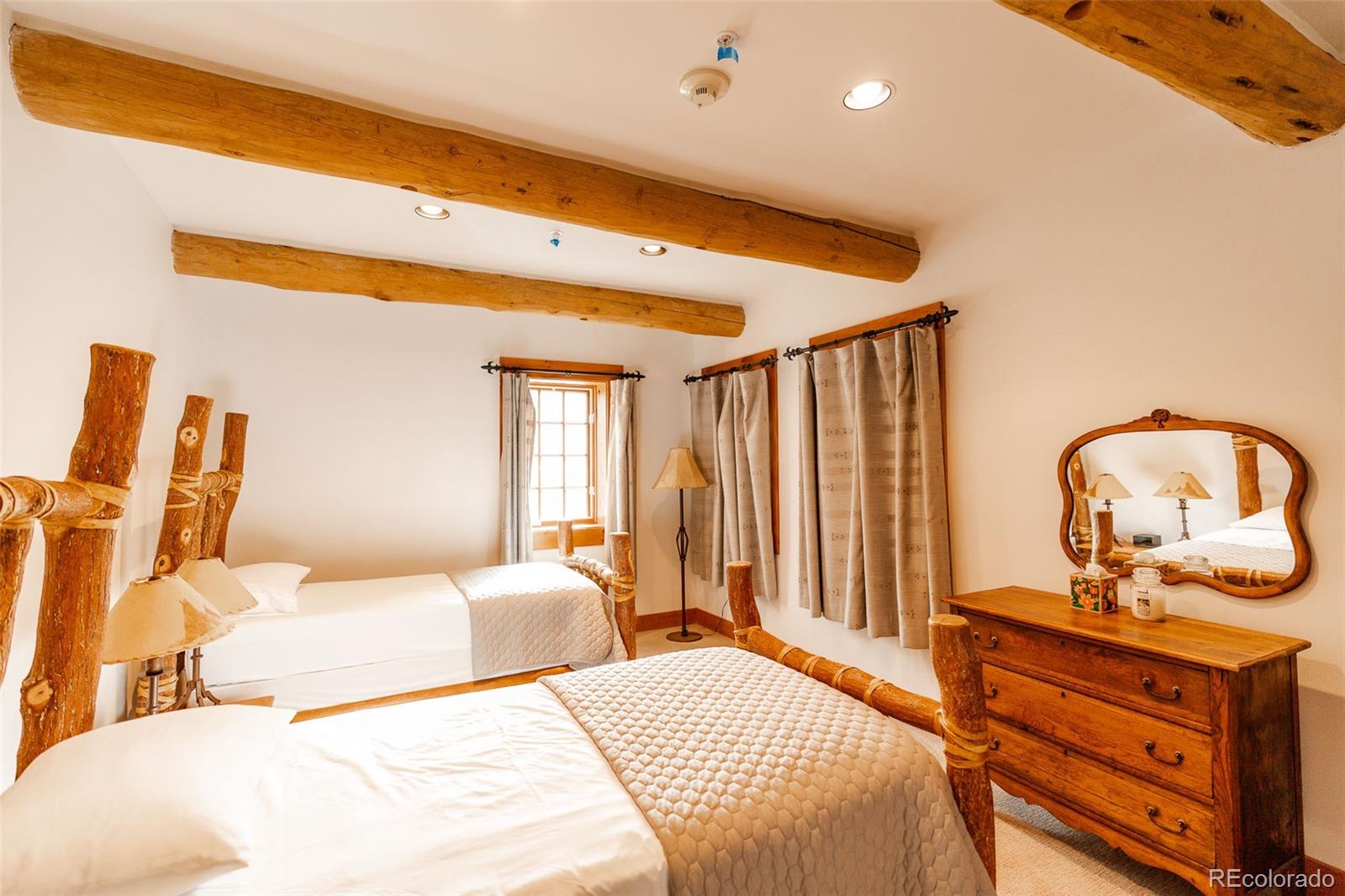 375 Pine Creek Road Sedalia, CO 80135 - Photo 32 of 48 a bedroom with a bed and wooden floor