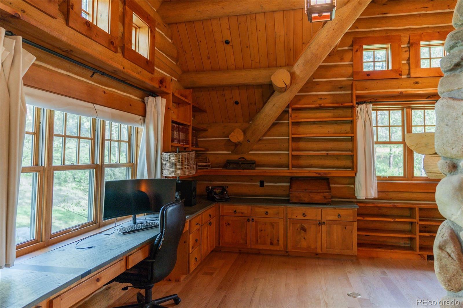 375 Pine Creek Road Sedalia, CO 80135 - Photo 34 of 48 a view of a room with wooden floor and furniture