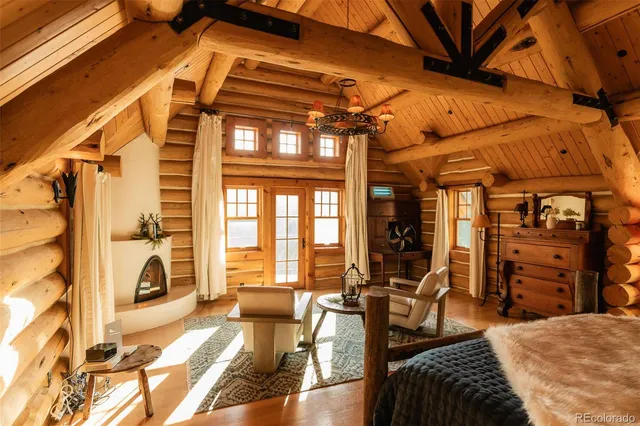 a living room with furniture a dining table and chairs with wooden floors