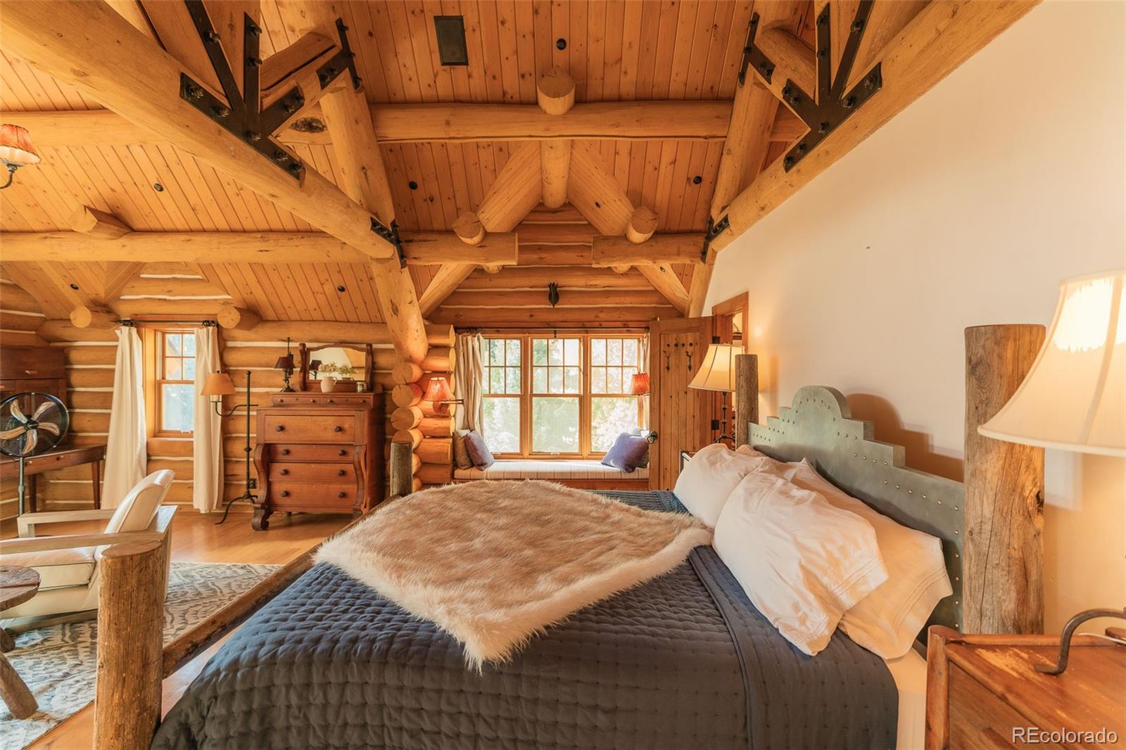 375 Pine Creek Road Sedalia, CO 80135 - Photo 37 of 48 a bedroom with a bed a table and chair