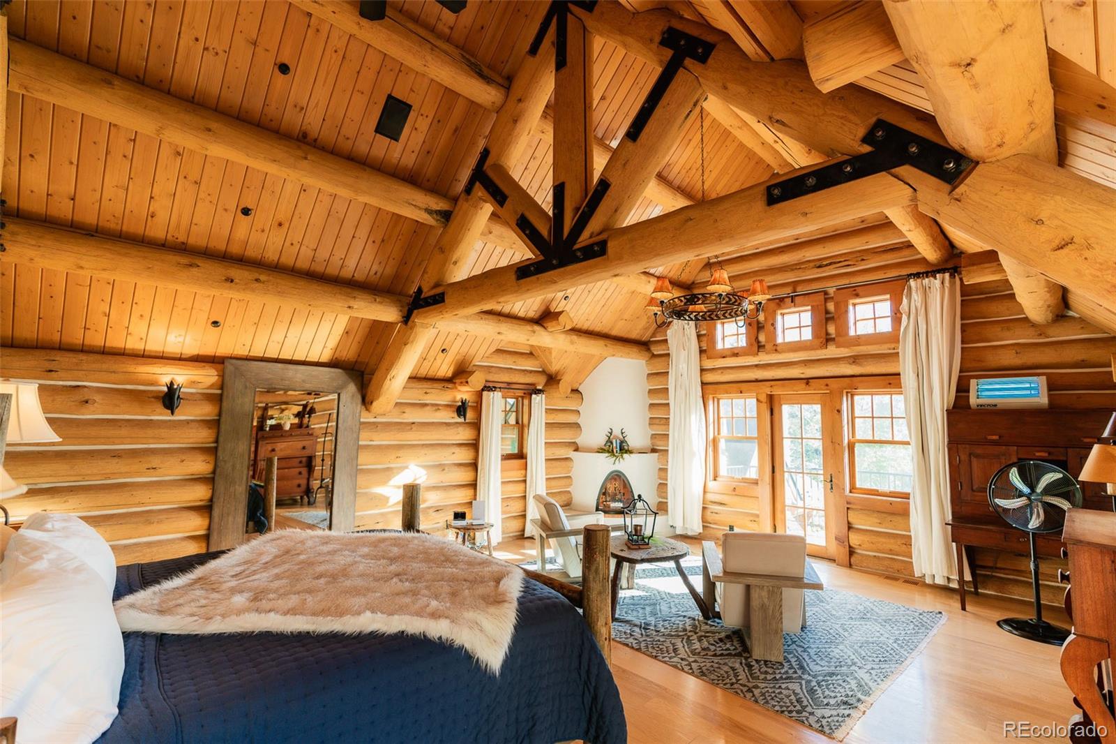 375 Pine Creek Road Sedalia, CO 80135 - Photo 39 of 48 a living room with furniture a dining table and chairs with wooden floors