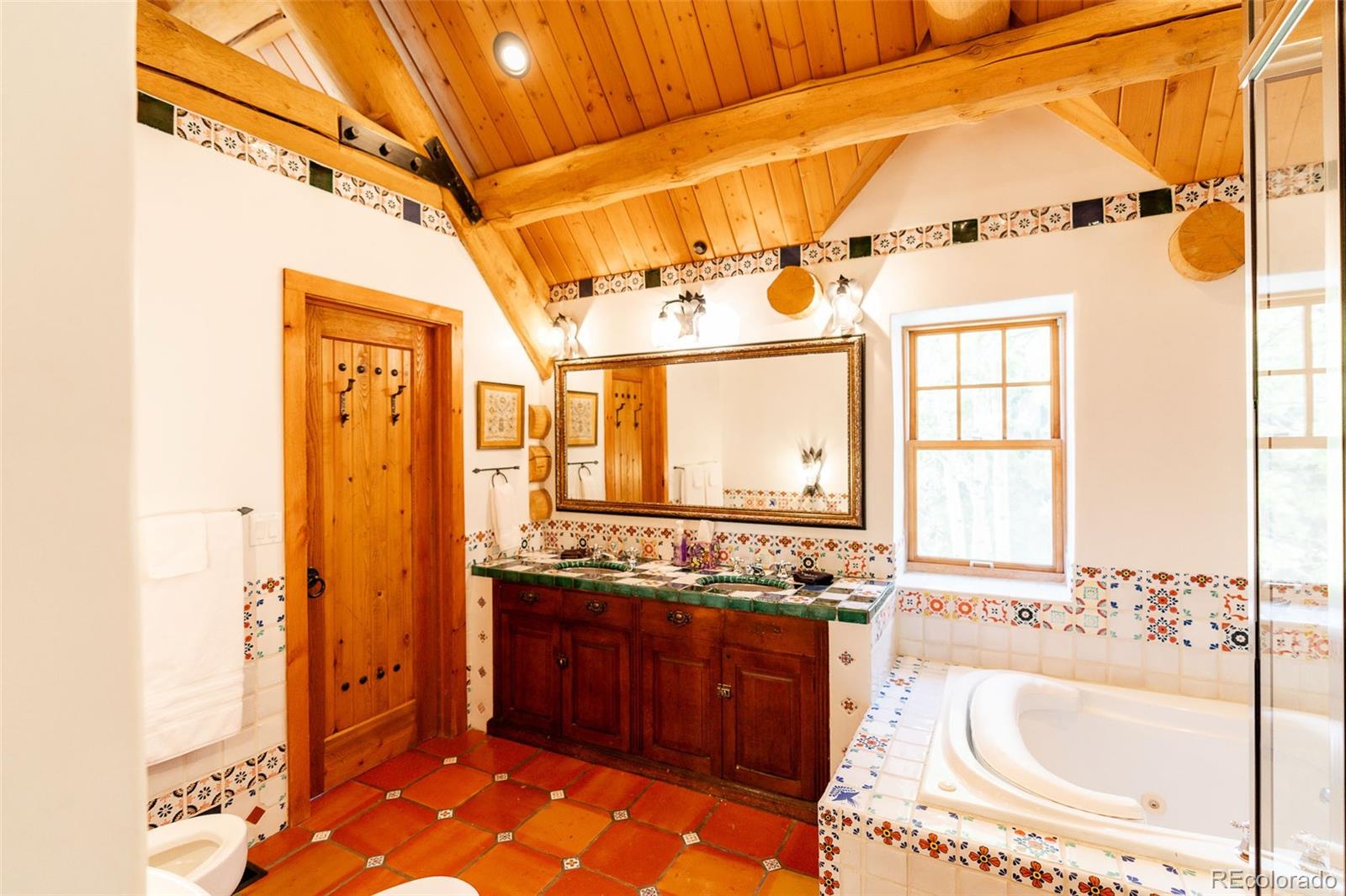 375 Pine Creek Road Sedalia, CO 80135 - Photo 40 of 48 a bathroom with a granite countertop sink and a mirror