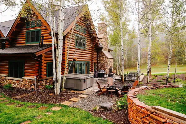 a backyard of a house with outdoor seating