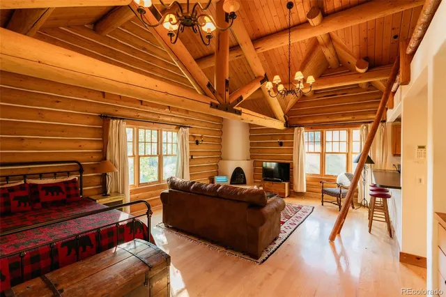 a living room with furniture a flat screen tv and a table