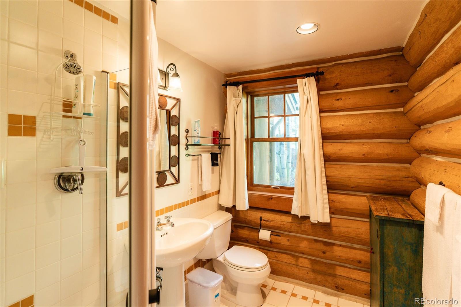 375 Pine Creek Road Sedalia, CO 80135 - Photo 46 of 48 a bathroom with a granite countertop sink toilet and shower