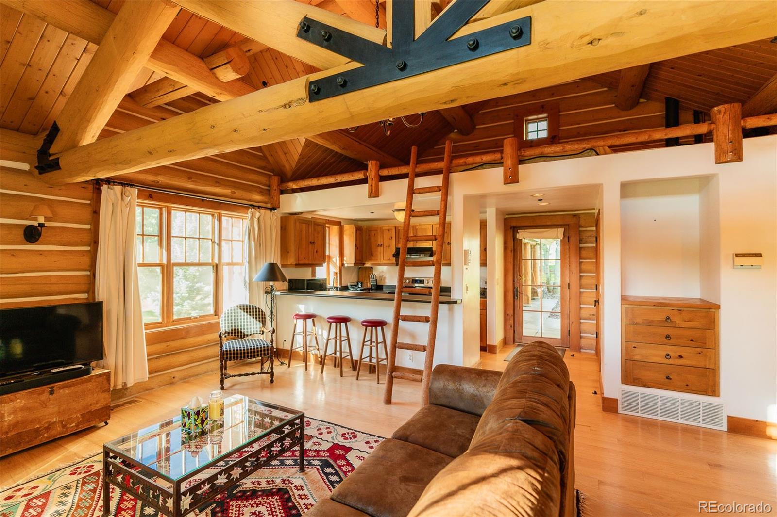 375 Pine Creek Road Sedalia, CO 80135 - Photo 47 of 48 a living room with furniture a flat screen tv and a table
