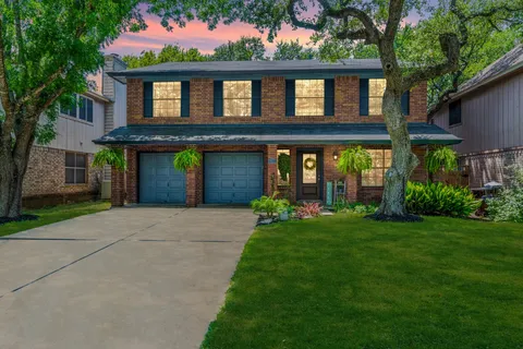 a front view of a house with a garden and porch