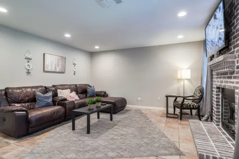 a living room with furniture and a lamp