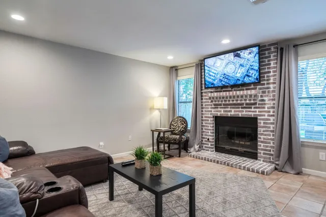 a living room with furniture a window and a fireplace