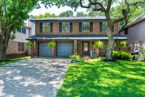 a front view of a house with a yard and porch