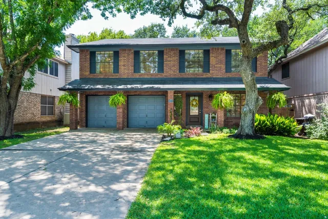 a front view of a house with a yard and porch