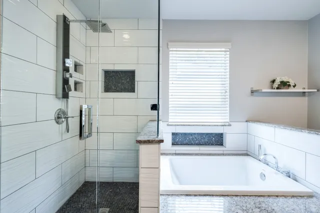 a bathroom with a bathtub and shower