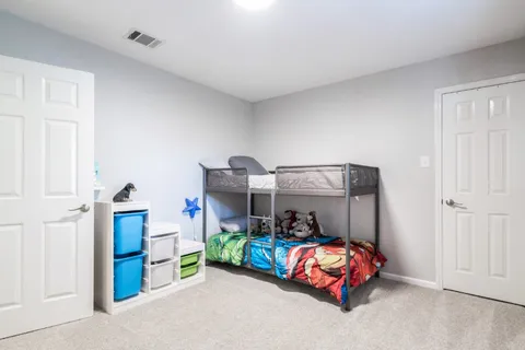 a bedroom with bed and window