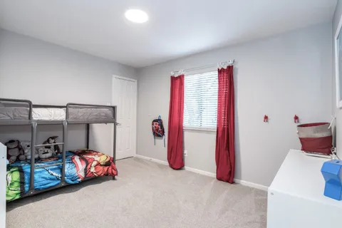 a bedroom with bed and closet