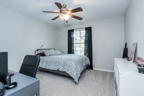 a bedroom with a bed and a desk