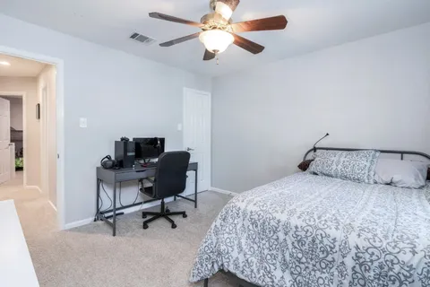 a bedroom that has a bed and a chair