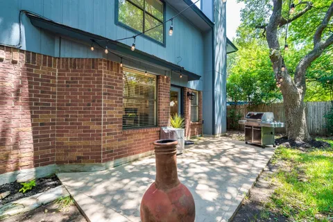 a view of a patio with table and chairs and potted plants