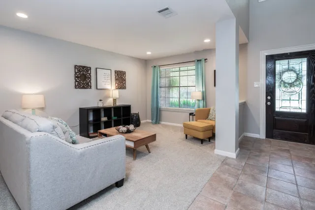 a living room with furniture and a fireplace