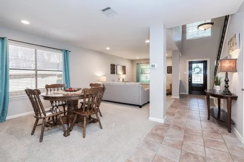 a view of a dining room with furniture and a large window