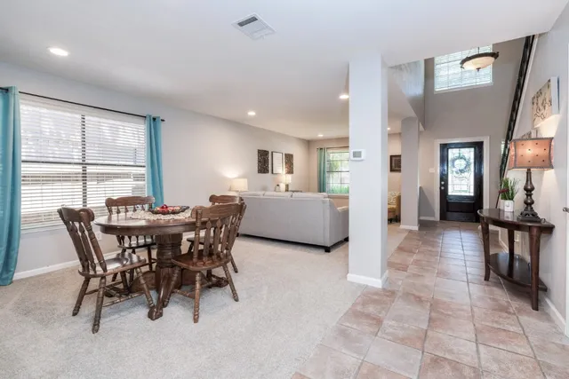 a view of a dining room with furniture and a large window