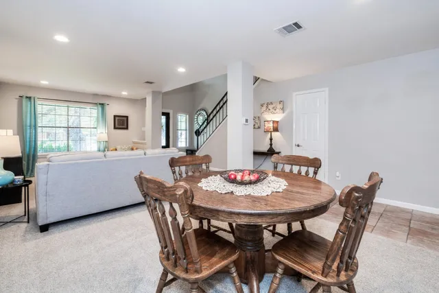 a dining room with furniture and window