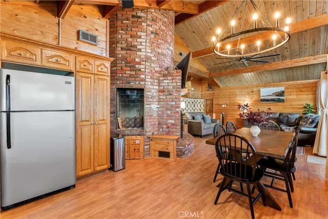a view of a dining room with furniture and a chandelier