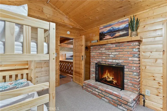 a living room with a fireplace wooden floor and a fireplace