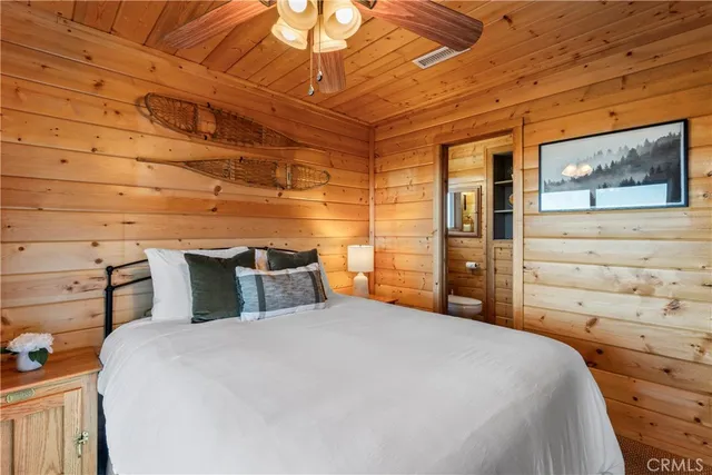 a bedroom with a bed and a wall painting