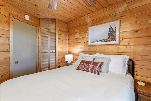 a bedroom with a bed and wall painting