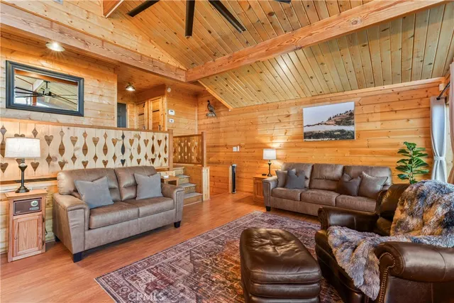 a living room with furniture a couch and a potted plant