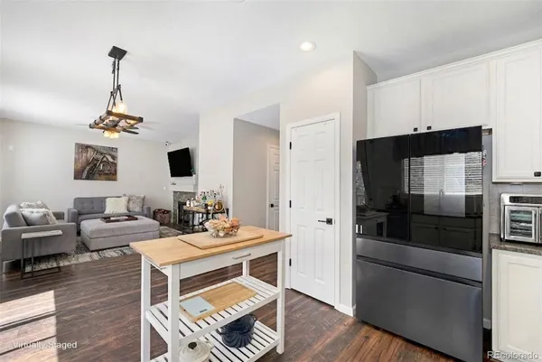 a living room with furniture and a kitchen