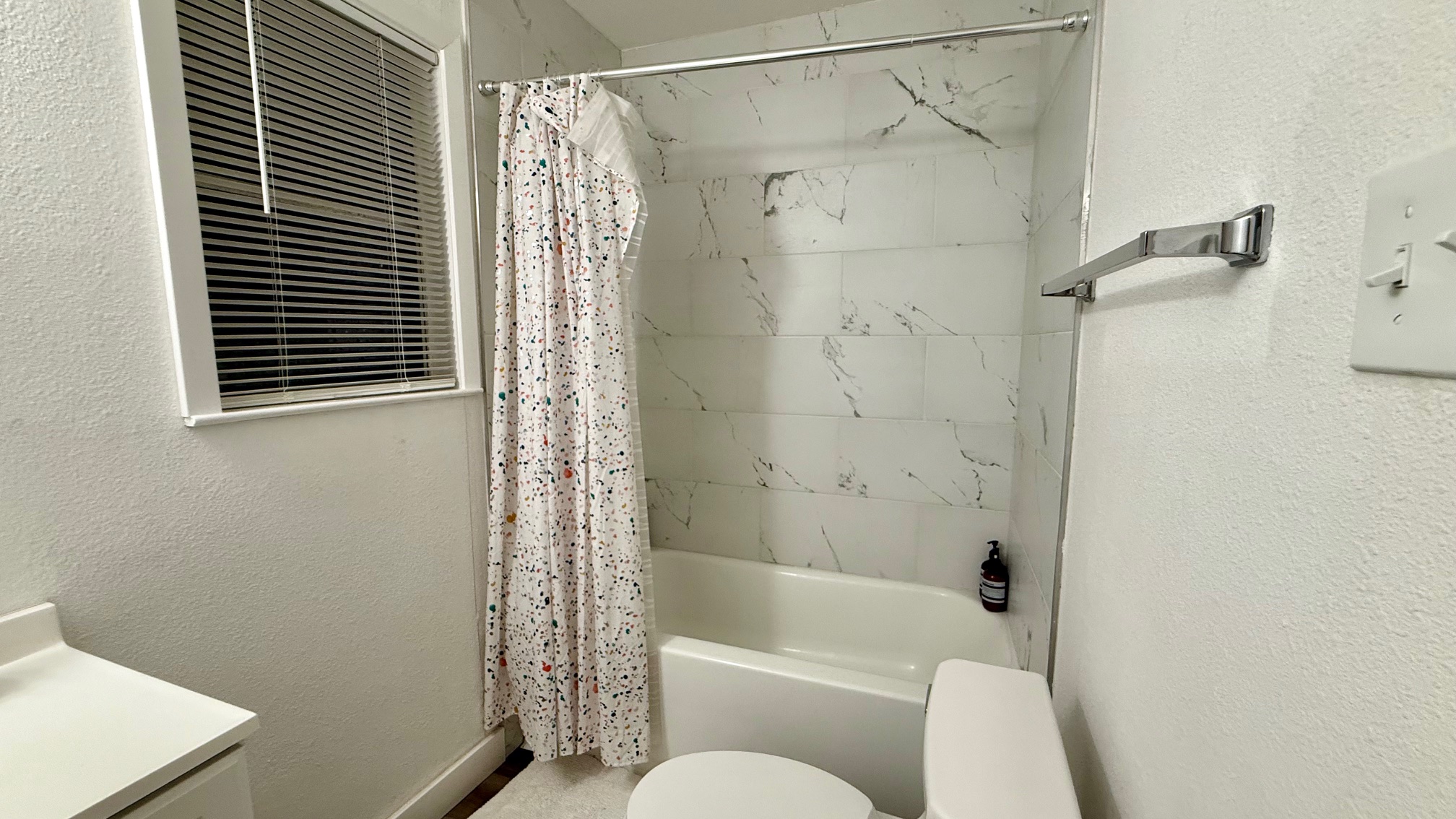 1802 East University Avenue Georgetown, TX 78626 - Photo 12 of 35 a bathroom with a shower curtain and a toilet