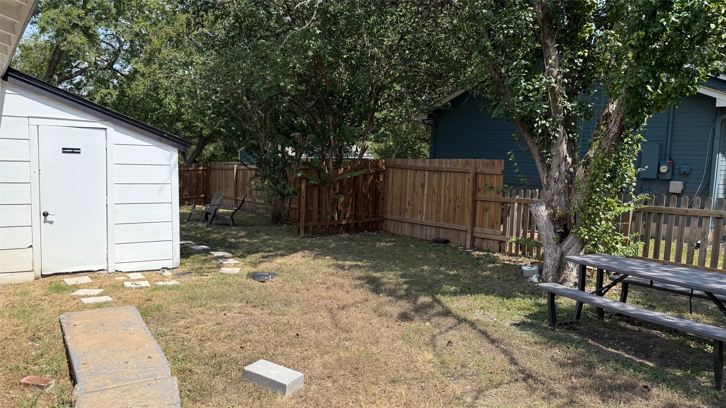 1802 East University Avenue Georgetown, TX 78626 - Photo 3 of 35 a backyard of a house with barbeque oven and trees