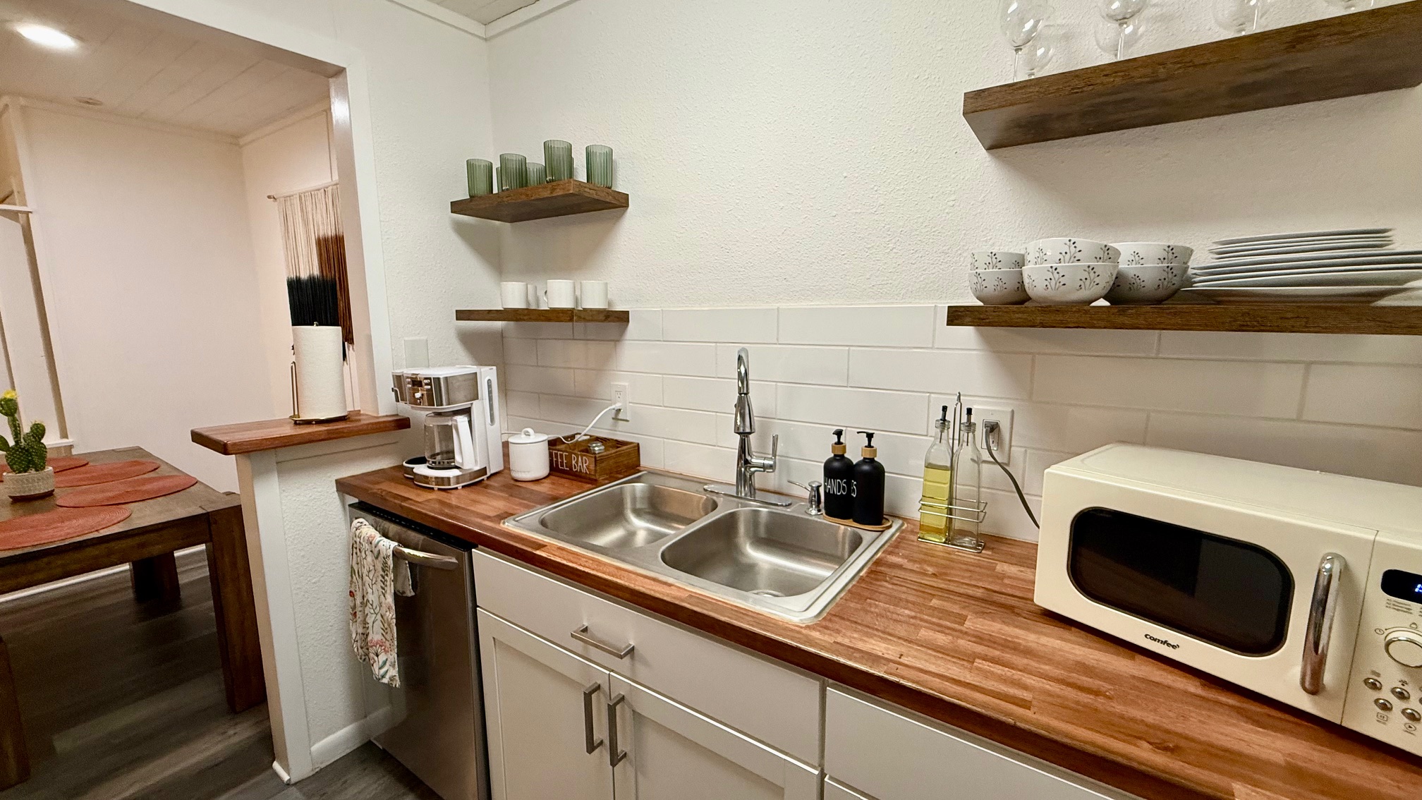 1802 East University Avenue Georgetown, TX 78626 - Photo 33 of 35 a kitchen with a sink and a stove with wooden floor