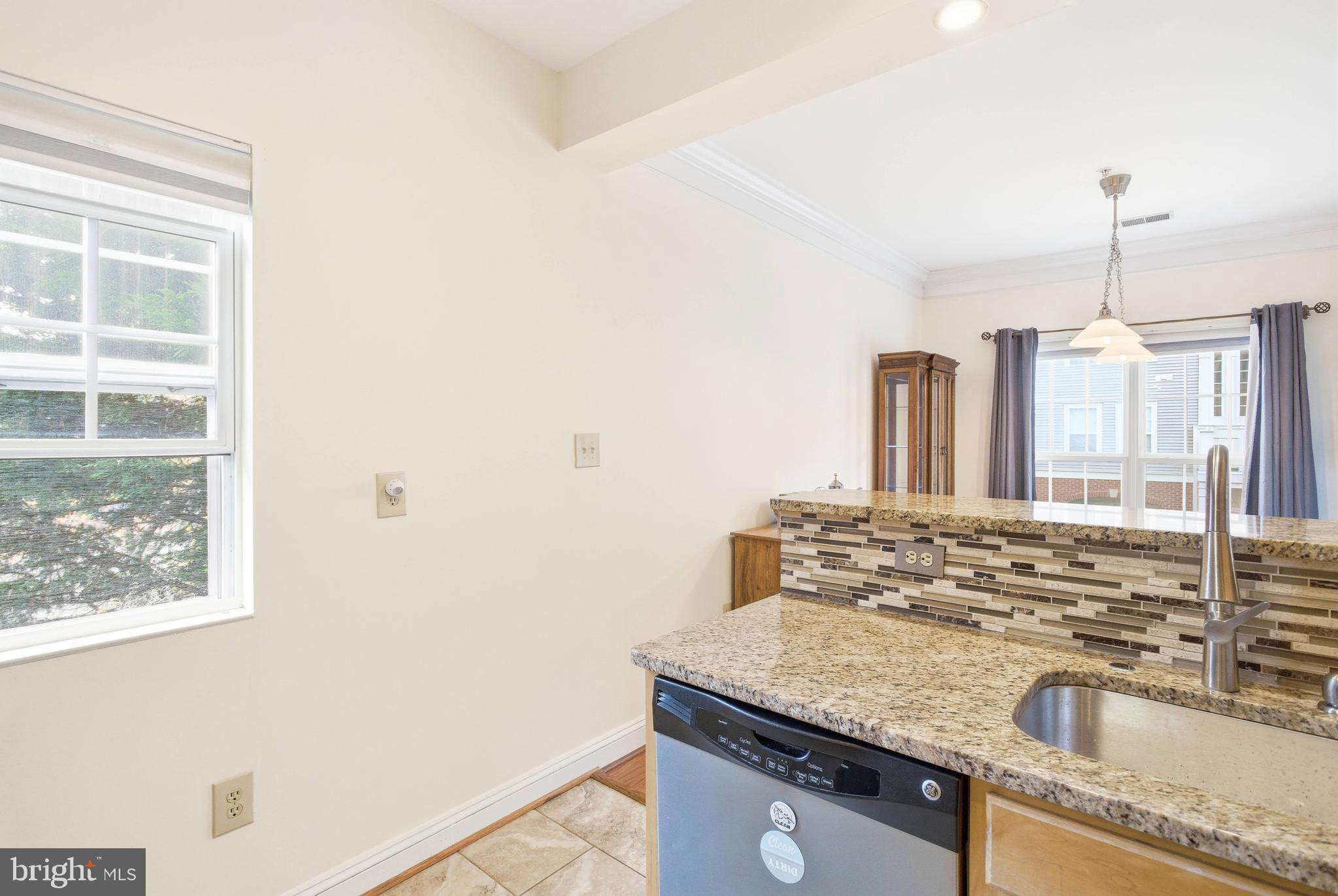 11302 Westbrook Mill Lane, Unit 204 Fairfax, VA 22030 - Photo 13 of 30 a kitchen with granite countertop a sink stainless steel appliances and a counter space