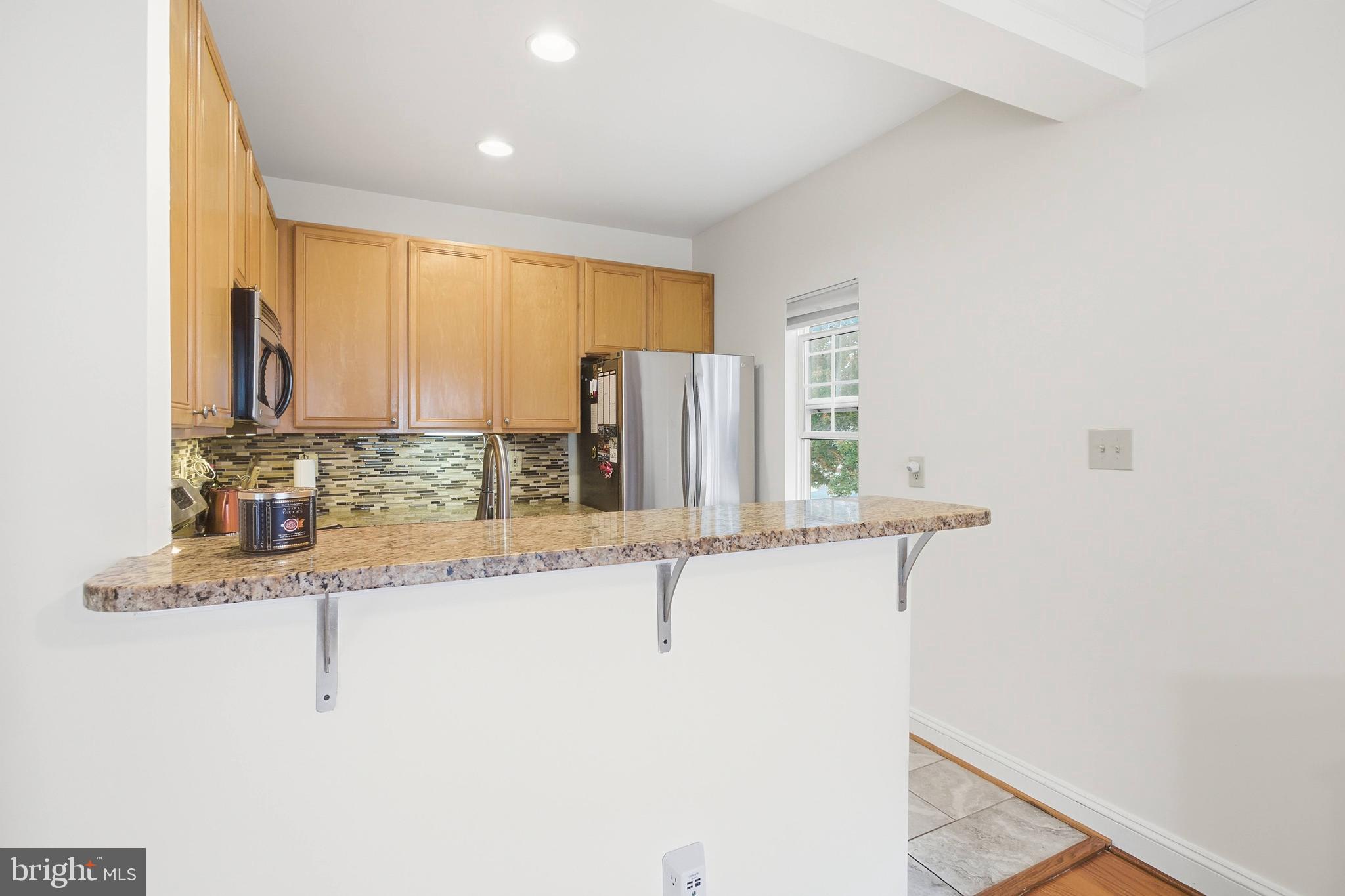 11302 Westbrook Mill Lane, Unit 204 Fairfax, VA 22030 - Photo 15 of 30 a bathroom with a granite countertop sink and a mirror