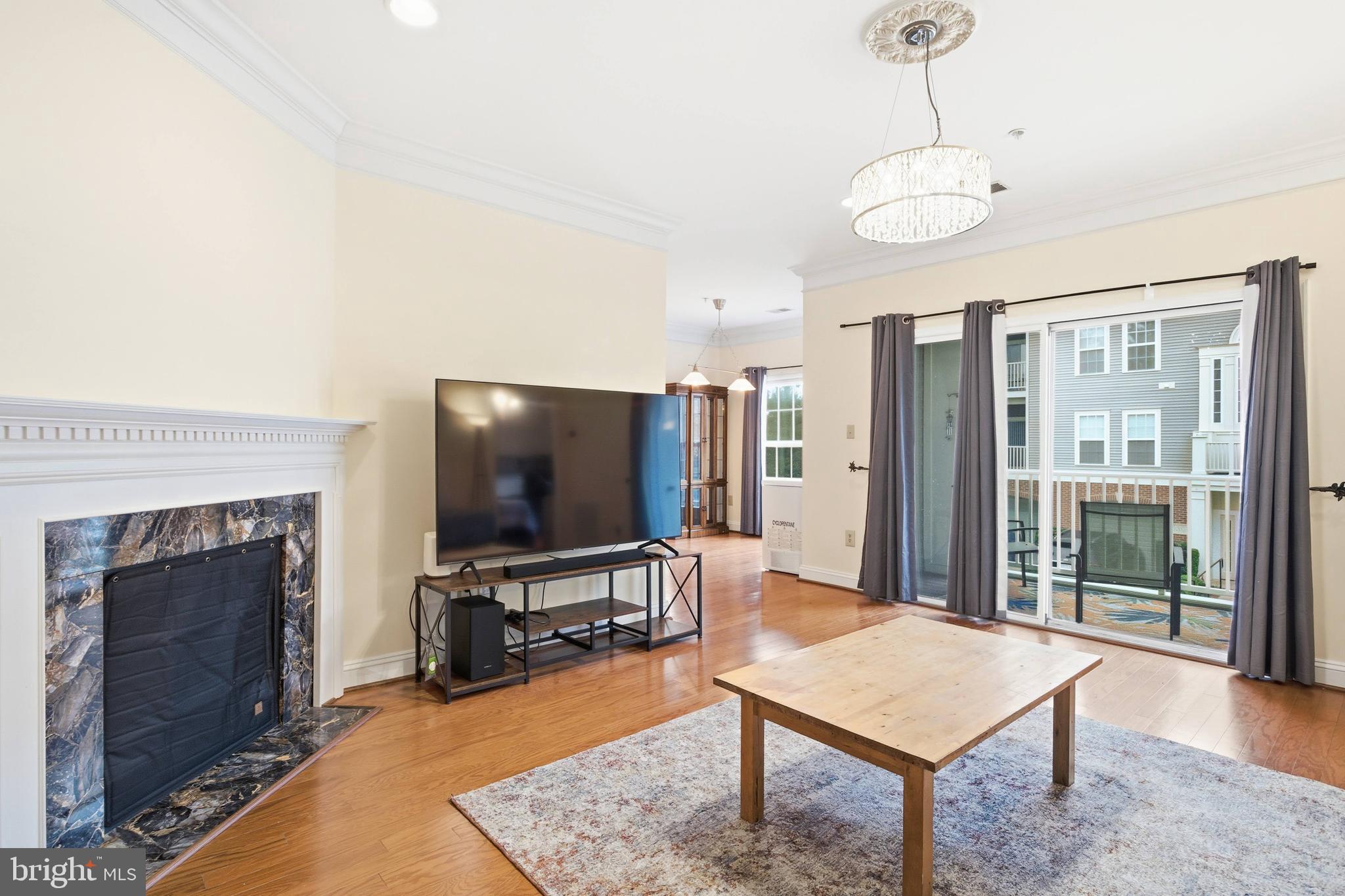 11302 Westbrook Mill Lane, Unit 204 Fairfax, VA 22030 - Photo 18 of 30 a living room with furniture a flat screen tv and a fireplace
